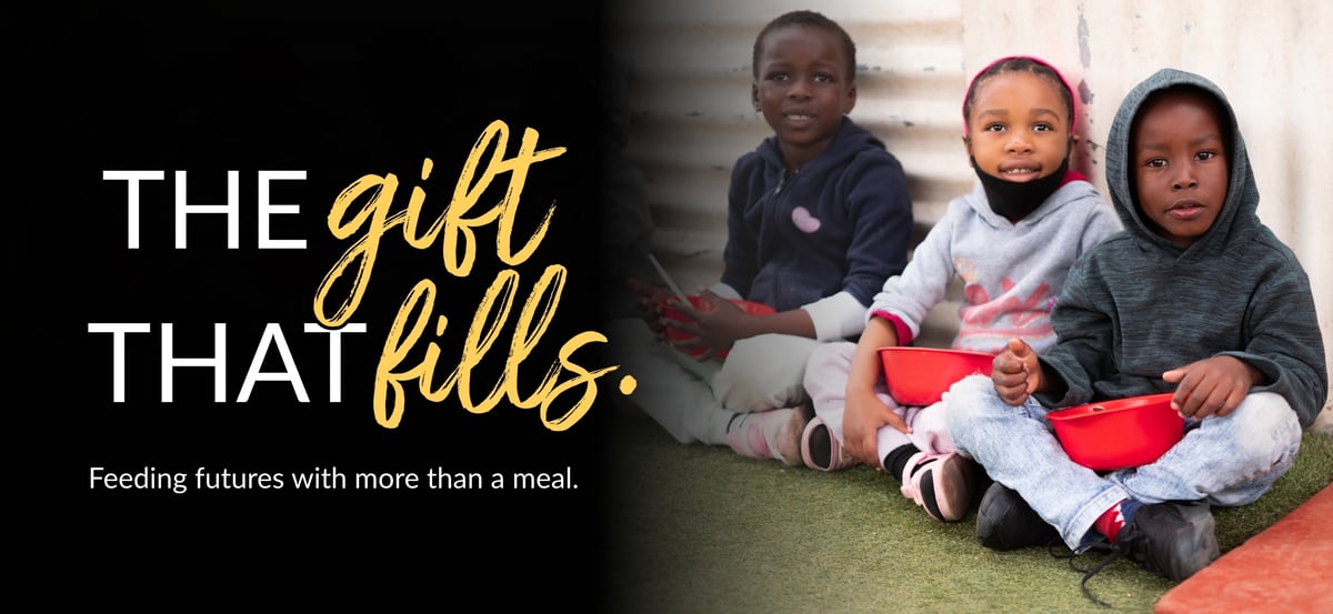 Email header image with "The Gift That Fills" wordmark and the tagline "Feeding futures with more than a meal." The photo is of children receiving Rise Against Hunger meals.