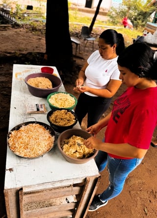 Community members preparing meals with their neighbors.