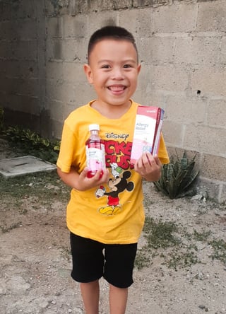 Sebastian smiling with the medication that healed his sickness.